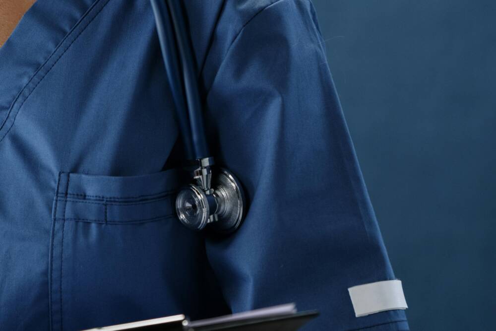 Blue-coated medical doctor with stethoscope in hospital or clinic service, healthcare concept